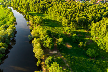 A picturesque landscape with a riverbed bathed in the rays of the setting sun, an aerial perspective, seen from aboveの写真素材