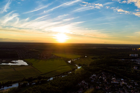 Aerial view of a picturesque sunset with rural landscape in the background