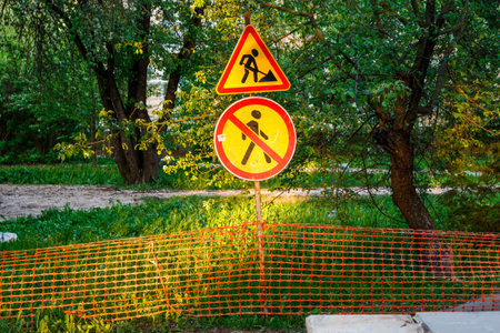 Enclosed netted area with no entry and work in progress signs on city street