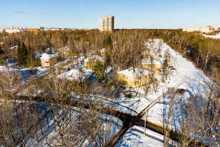 Winter snowy landscape of an old residential area on the outskirts of the city, identical two-story residential buildingsの写真素材