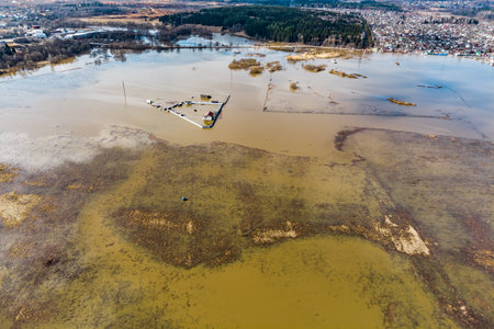 Bird's eye view of flooded floodplain fields in rural area during spring floodの写真素材
