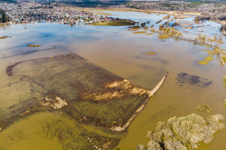 Bird's eye view of flooded floodplain fields in rural area during spring floodの写真素材