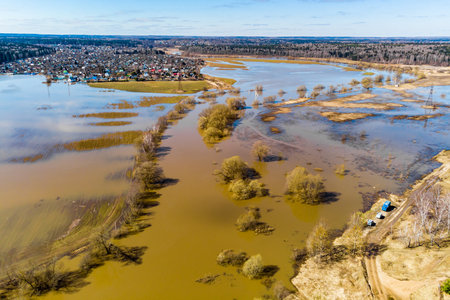 The floodplain, which is a low-lying area, was inundated with water during the spring flood of the river, aerial viewの写真素材