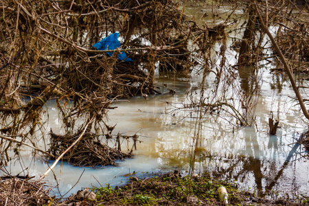Spill of contaminated bluish water after dumping of industrial wasteの写真素材