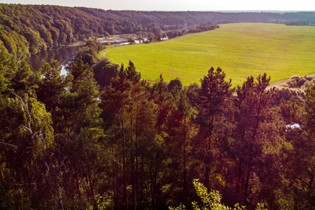 Drone takeoff over trees on river bankの写真素材