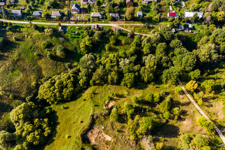 Flight over countryside with village houses, Russia