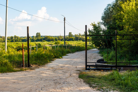 Industrial zone gate construction underway on a dusty country road