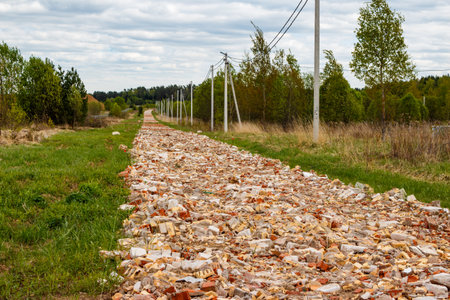 Backfill of broken bricks for laying a country road on the territory of a future settlementの写真素材