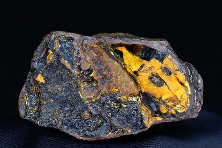 Striking yellow and black goethite limonite specimen, a vibrant mineral sample from Russia's Kaluga region on a dark backdropの写真素材