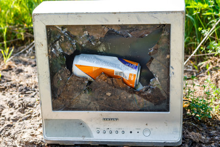 Old broken Samsung TV with a cracked picture tube and a beer can inside: Russia - June 2, 2025のeditorial素材