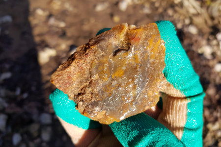 Chalcedony fragment stained with iron oxides found near water