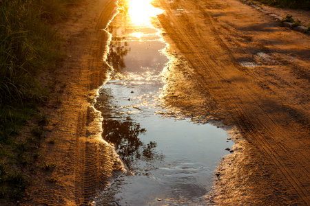 A picturesque view of water running along a country roadの写真素材