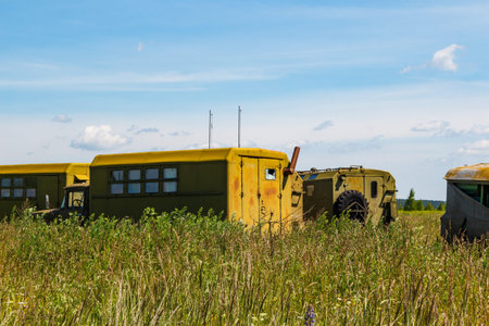 Old Soviet military transport parked in overgrown field, Russiaの写真素材