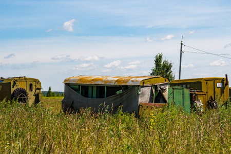 Old Soviet military transport parked in overgrown field, Russiaの写真素材