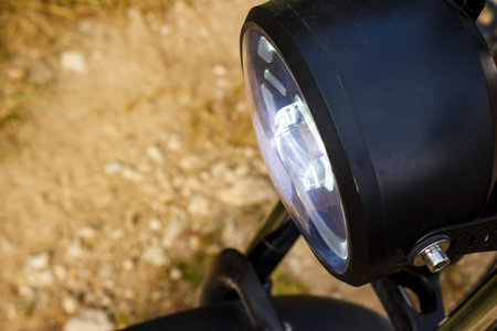 Illuminated motorcycle or e-bike front headlightの写真素材