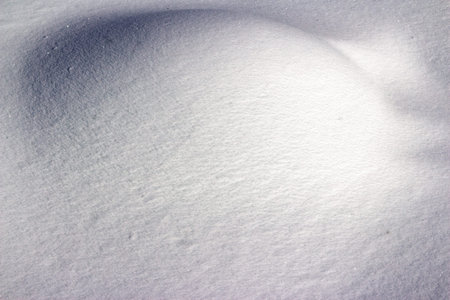 Sparkling fresh snow, a pristine winter wonderland texture. Gentle drifts and subtle shadows define...