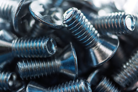 Macro shot of bright galvanized DIN 965 screws, showing precise threads and a lustrous metallic...