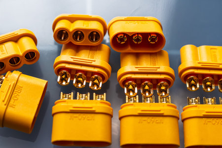 Vibrant yellow MR60 power connectors, male and female, for motor wiring. Shiny gold-plated contacts...