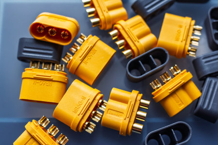 Close-up of Amass MR60 power connectors, male and female, showcasing their shiny gold-plated brass pins against a muted background for electric motor and transport applications: Russia - March 2, 2026
