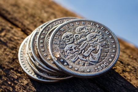 Stack of souvenir pirate coins with skulls and Latin inscription Carpe diem, Hobo Nickel coins