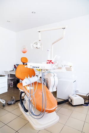 The chair at the dental clinic. Tool dentist. Admission to Dentistry. Orange chair.の写真素材