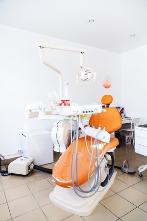 The chair at the dental clinic. Orange chair. Tool dentist. Admission to Dentistry.の写真素材
