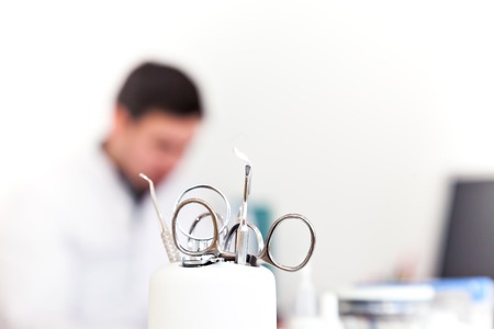 In the dentist's chair in the clinic. Tools. A doctor in the background. Admission to the dentist's office.の写真素材