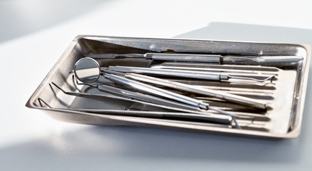 Set of metal Dentist 's medical equipment tools. dental instrument set in stainless trayの写真素材