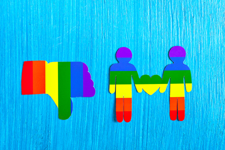 Two paper man with a heart of rainbow. Flag Colors of homosexuality. the relationship between the two men. Dislike hand symbol. Thumbs down. Same-sex love. Minorities. Logo LGBT.の写真素材