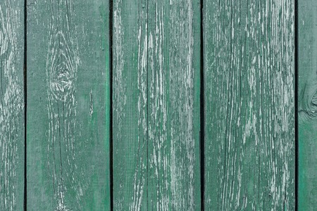 Different shades of green texture wood planks as a background nature. Peeling paint on an old green...