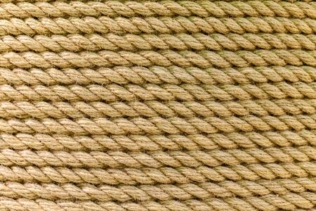 Perfect yellow rough rope texture. Close-up. The texture of the rope with copy space.