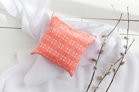aromatherapy pillows, aromatization space. Miniature decorative pillows pale pink with lace. Handmade. White wooden background, willow twigs and feathers.の写真素材