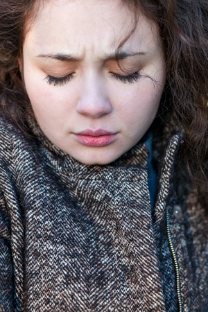 gloomy portrait of a young girl. Sad face thinking about problems