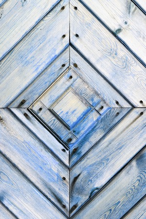 Old wooden wall texture or background with copy space. Wooden old boards diagonally in a diamond shape. Detail of the door.の写真素材