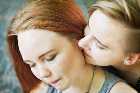 LGBT women. Young lesbian couple walking in the park together. Delicate relationship. The notion of same-sex marriage. Selective focus.の写真素材