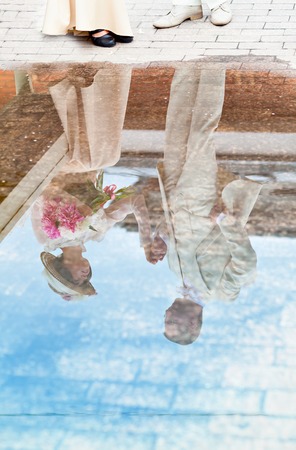 Beautiful young woman in dress and hat portrait in retro style. The young gentleman and lady. Vogue Clothing in vintage styleの写真素材