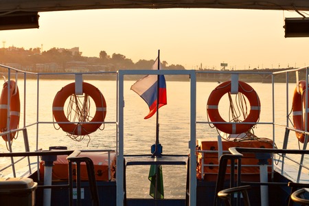 Lifebuoys and Russian flag on board the ship on sunset backgroundの写真素材