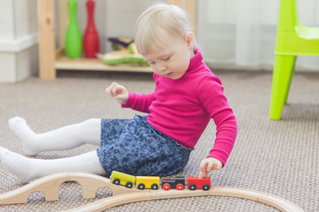Little girl playing with trainの写真素材