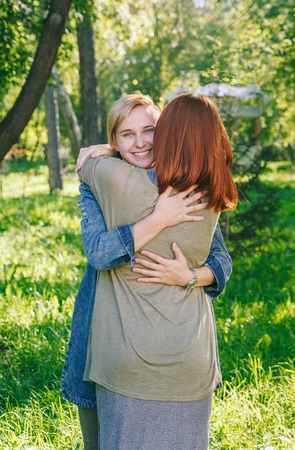 alternative couple hugs and laughsの写真素材