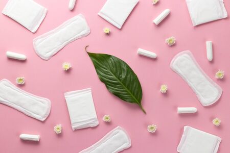 Tampons, feminine sanitary pads on a pink background. Hygienic care on critical days. menstrual cycle. Caring for womens health. Monthly protection. Flat lay, top view, copy space.の写真素材