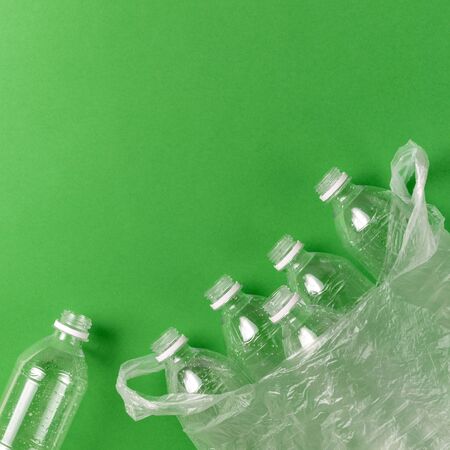 Composition of plastic waste pollution. Sorting and recycling. Disposable plastic bottles for water. Ecological concept. Flat lay, top view, copy space.の写真素材