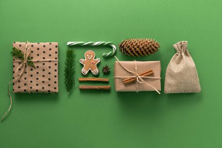 Christmas composition. Creative christmas background. Christmas decorations and fir branches create an ornament and texture on a green background. Flat lay, top view, copy space.の写真素材