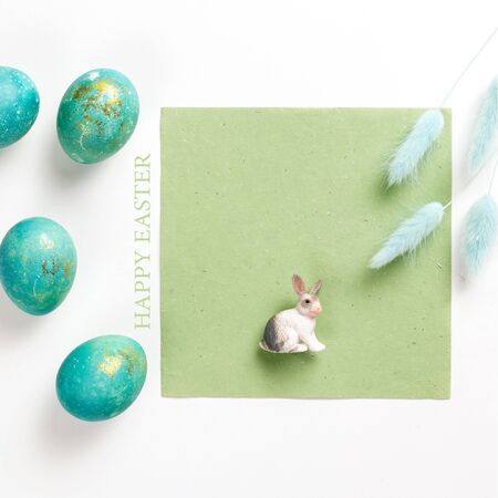 Happy easter card. Stylish minimalistic composition of turquoise with gold easter eggs on a white...