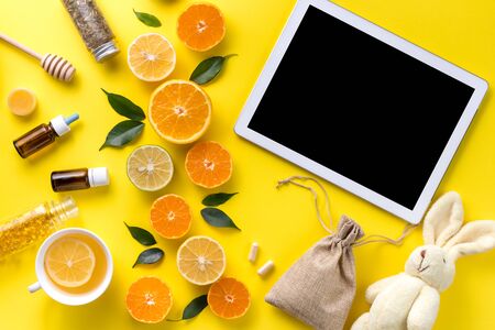Illness concept. Composition alternative medicine. Herbal tea, ginger and lemon on a yellow background. Childs health. Flat lay. View from above. Copy spaceの写真素材
