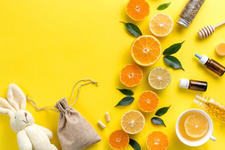 Illness concept. Composition alternative medicine. Herbal tea, ginger and lemon on a yellow background. Child's health. Flat lay. View from above. Copy space.の写真素材