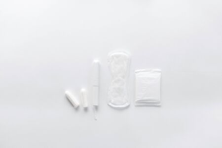 Tampons, feminine sanitary pads on a white background. Hygienic care on critical days. menstrual cycle. Caring for women's health. Monthly protection. Flat lay, top view, copy space.の写真素材