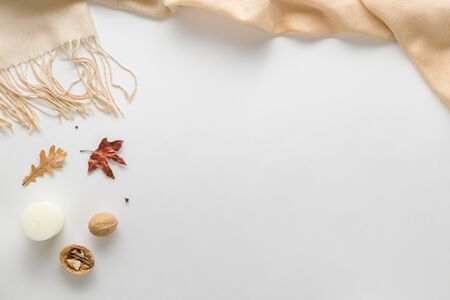 Autumn composition. plaid, candle, dried leaves on a white background. Autumnal, flat lounger, top...