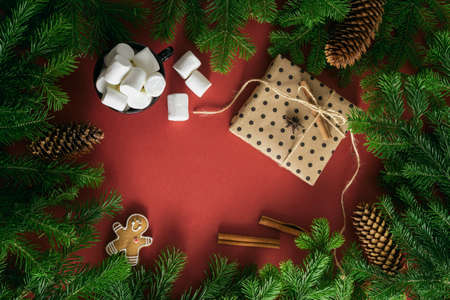 Christmas card. Composition from Christmas decorations, marshmallows, postcard and branches of fir...