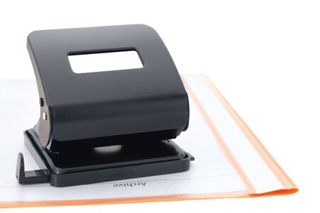 Black eyelet-puncher and orange archive folderの写真素材