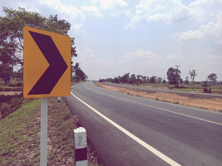 Warning signs for curves, please drive carefully and reduce driving speed.の写真素材